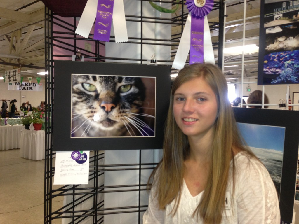 A reserve champion ribbon for Jasmine's photography as well as three pictures qualifying for state fair
